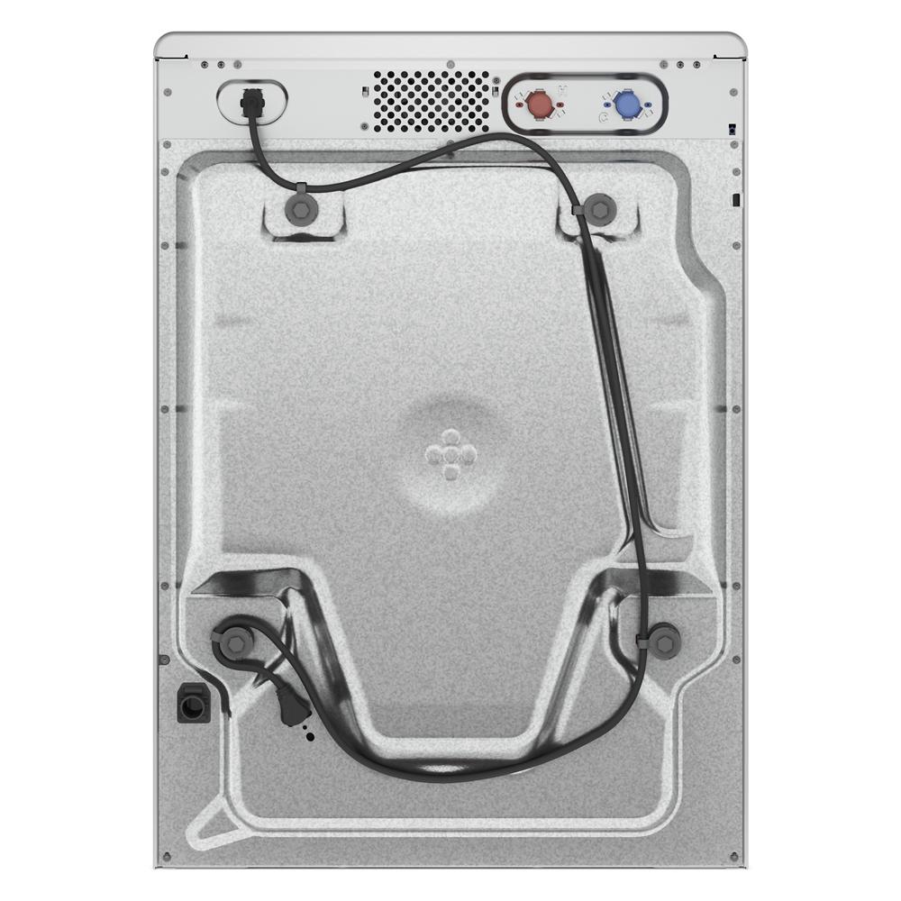 Back view of a gray metal front load washer panel with water line connections and power cord in appliance setting