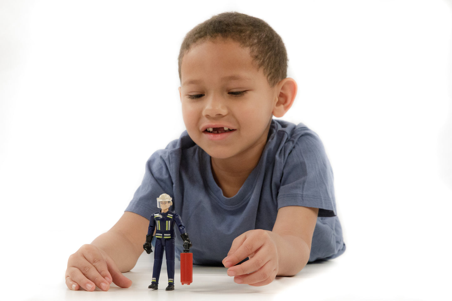 Child playing with 1:16 scale fireman figure holding red suitcase from Bruder Toys in Toys & Games collection