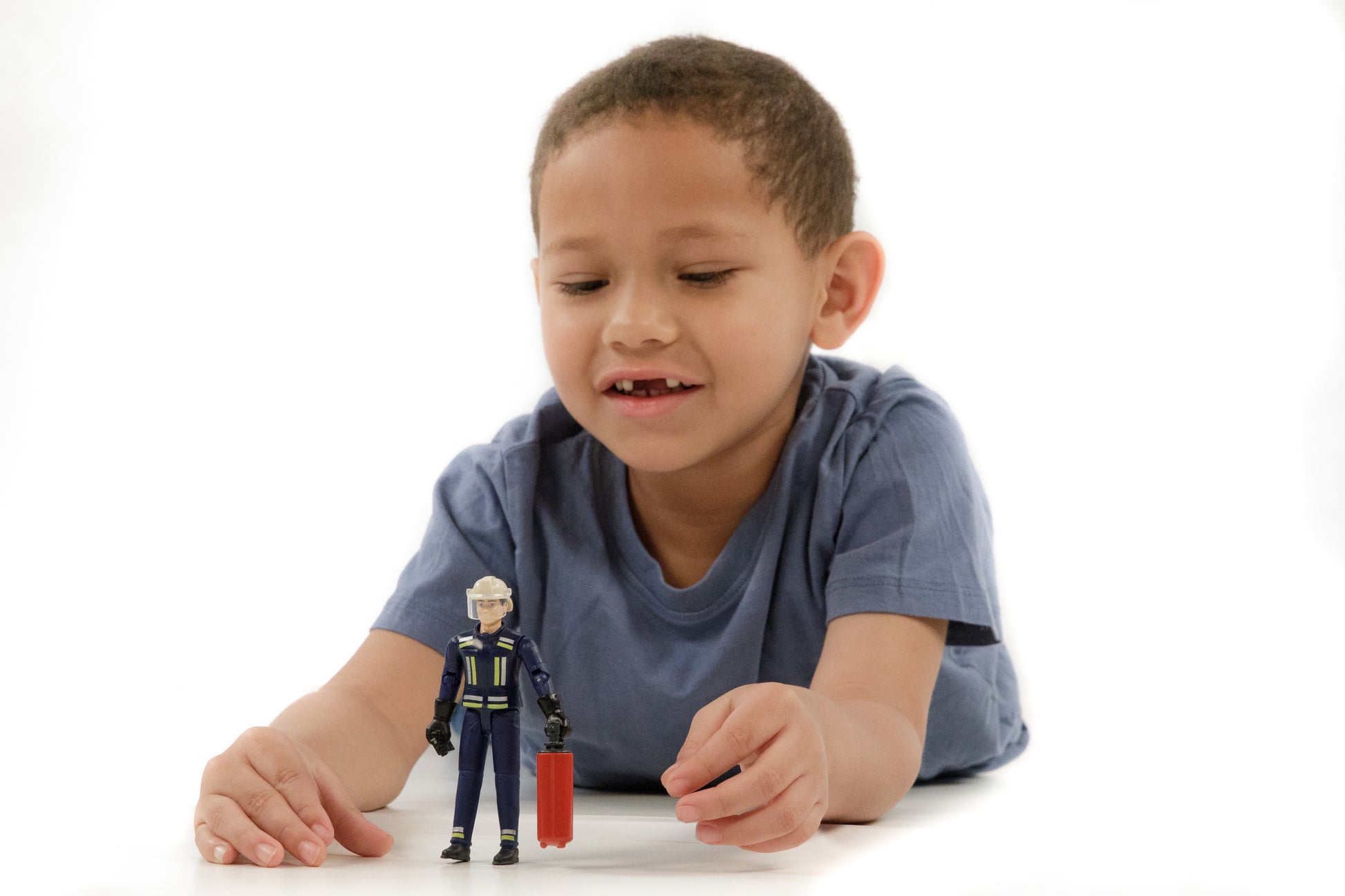 Child playing with 1:16 scale fireman figure holding red suitcase from Bruder Toys in Toys & Games collection