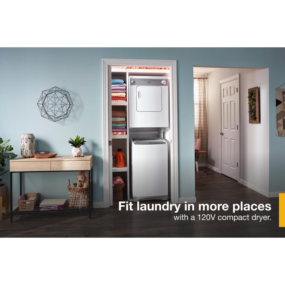 Compact white front load dryer stacked above matching washer in a small laundry closet with shelves and folded towels