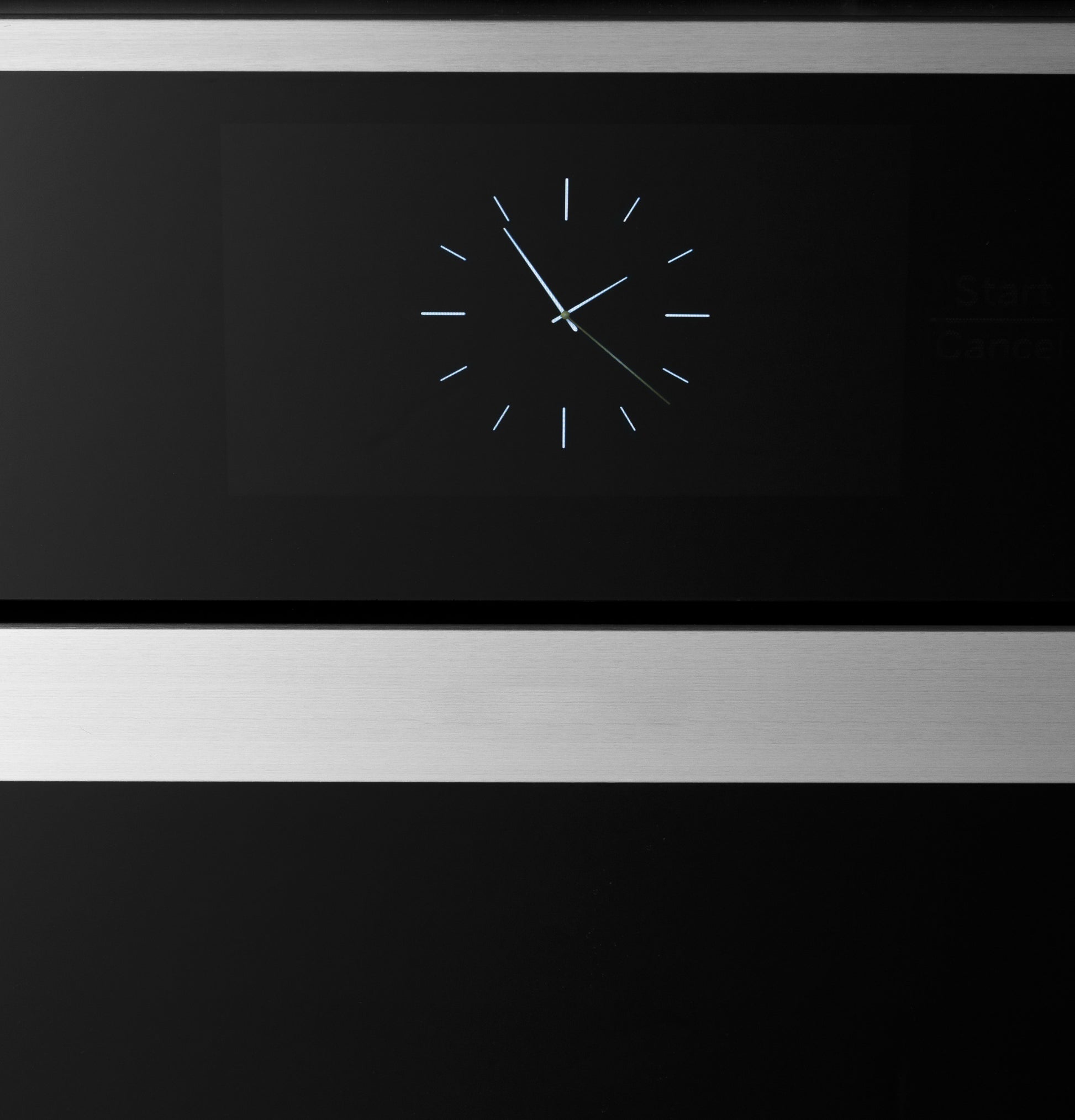Close-up of stainless steel trimmed black glass digital clock on modern double wall oven from kitchen appliances collection
