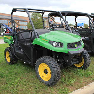 Green mid-size crossover utility vehicle with rugged Maxxis Bighorn tires and protective roll cage for outdoor tasks