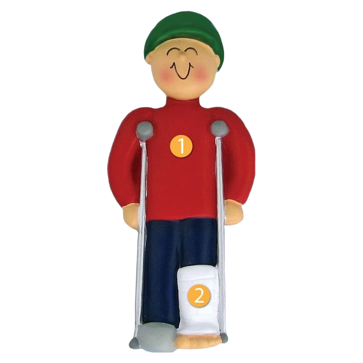 Smiling male ornament wearing green cap and red shirt on crutches with a cast, in Christmas Ornaments & Tree Decorations collection