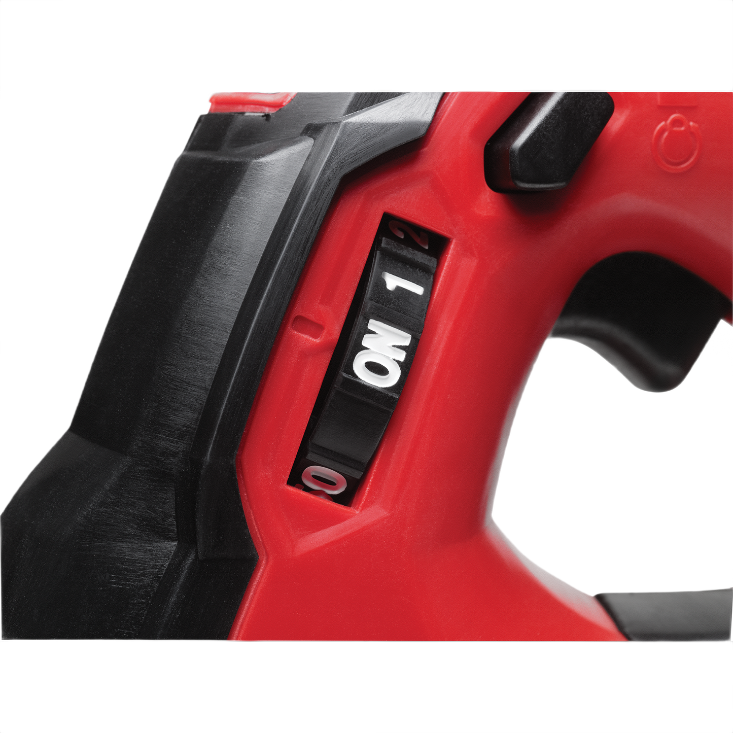 Close-up of red and black cordless grease gun speed selector switch for tools and home improvement tasks