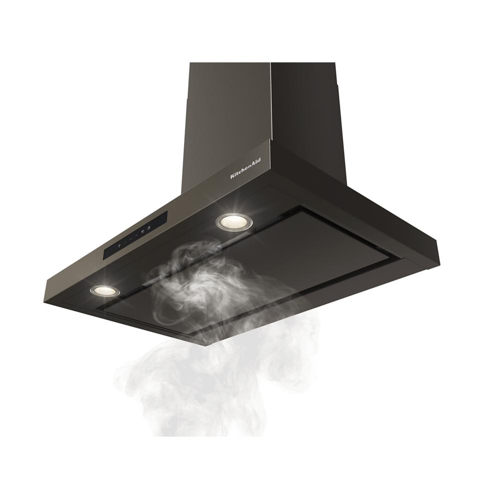 Matte black wall-mounted canopy hood with LED lights and active ventilation clearing kitchen smoke efficiently