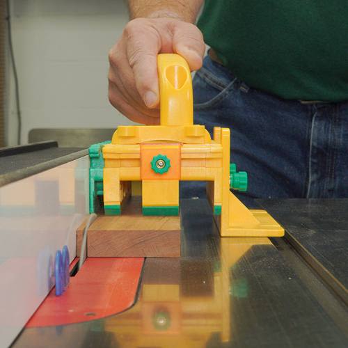 Yellow and green woodworking push block ensuring precise control and safety in power tool and saw accessories collection