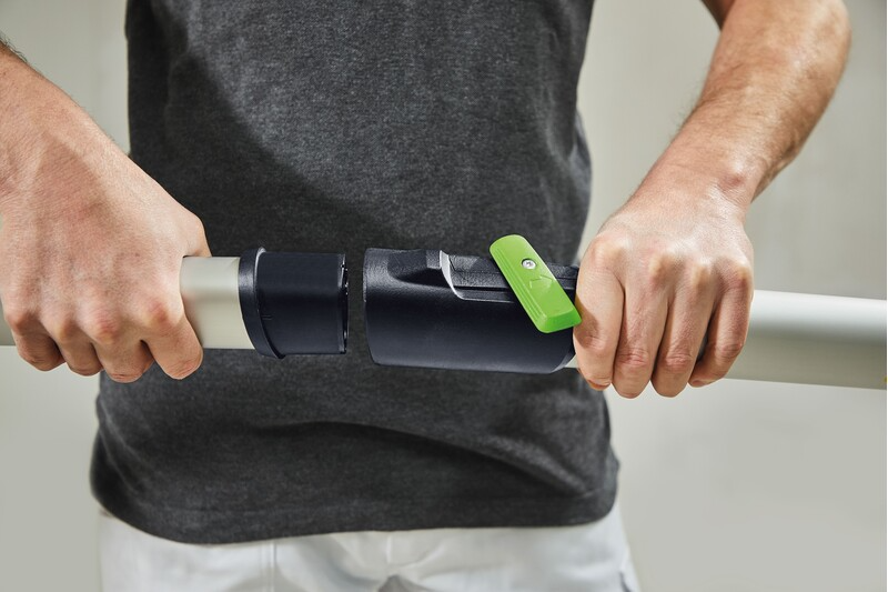 Person attaching a black and silver Festool Planex guide extension with green lever in power tool accessories collection
