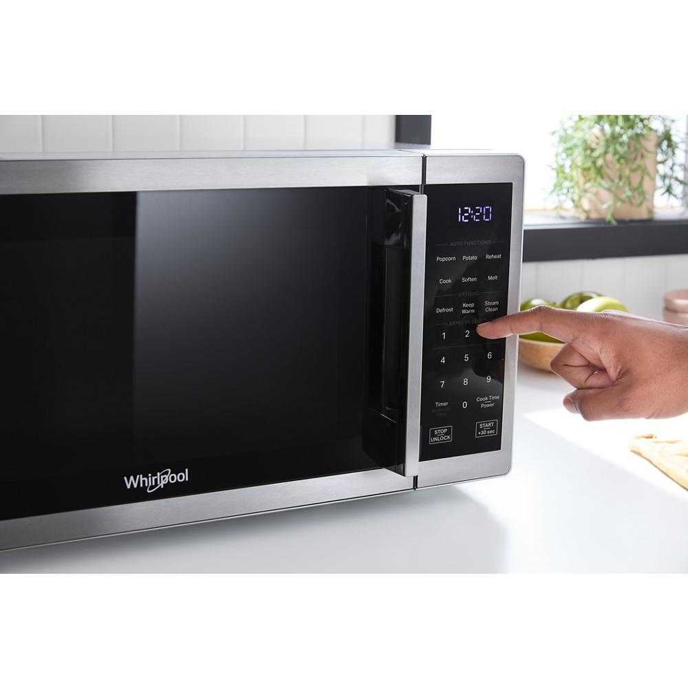 Stainless steel countertop microwave with white LED display and electronic touch controls in kitchenware collection