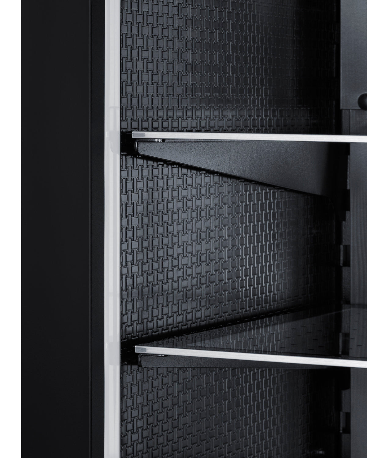 Interior view of built-in beverage center showing textured black back panel and metal shelf supports in kitchen appliance
