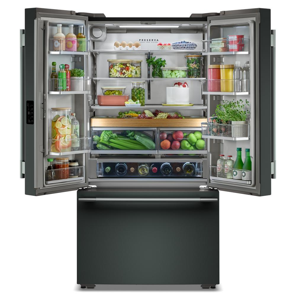 Open counter-depth French door refrigerator with organized fresh produce, drinks, and pantry items inside from KitchenAid collection