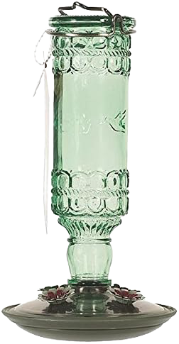 Green glass antique-style hummingbird feeder with four flower-shaped feeding ports and metal hanging hook