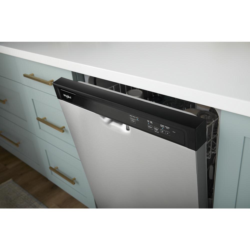 Partially open stainless steel dishwasher with black control panel integrated into light blue kitchen cabinetry and brass handles