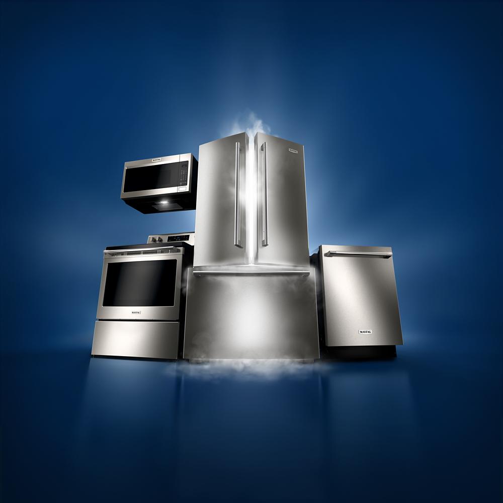 stainless steel French door refrigerator with bottom freezer surrounded by kitchen appliances in refrigerators collection