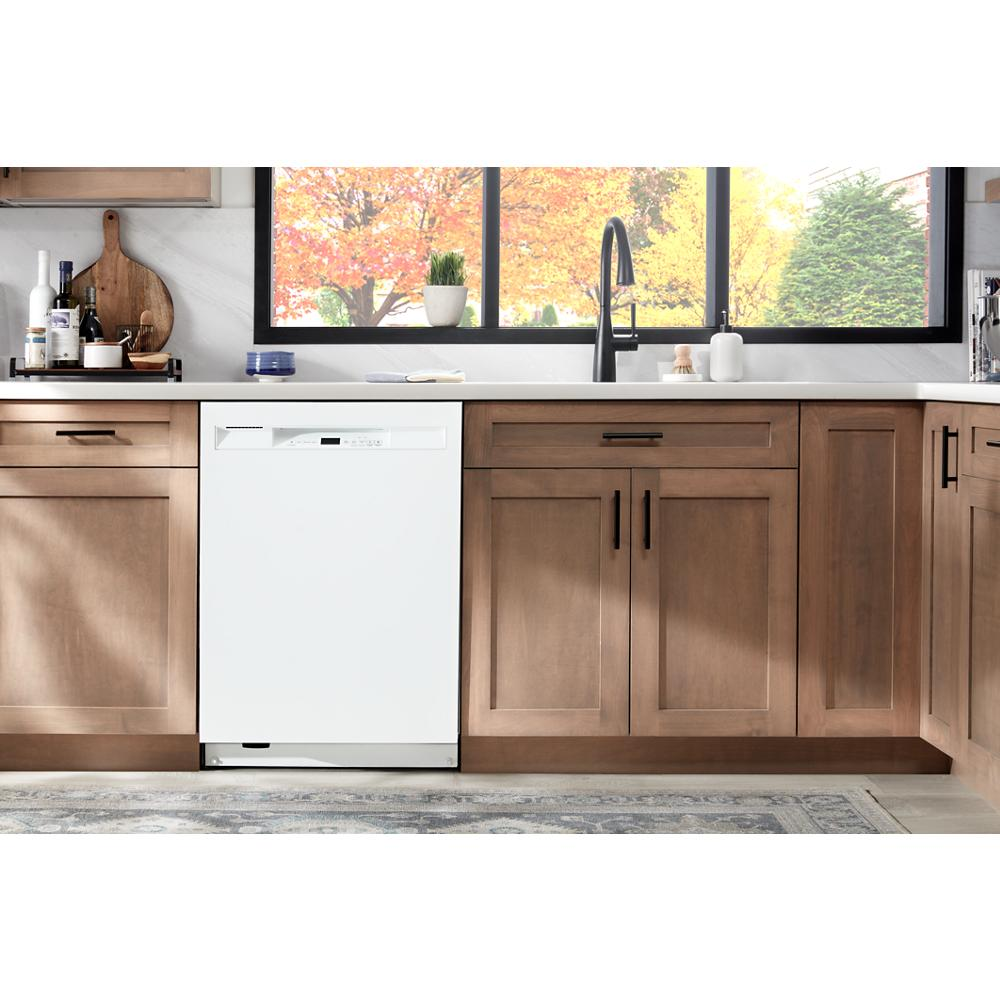 Built-in white front control dishwasher integrated within wooden kitchen cabinetry in appliances and home improvement setting