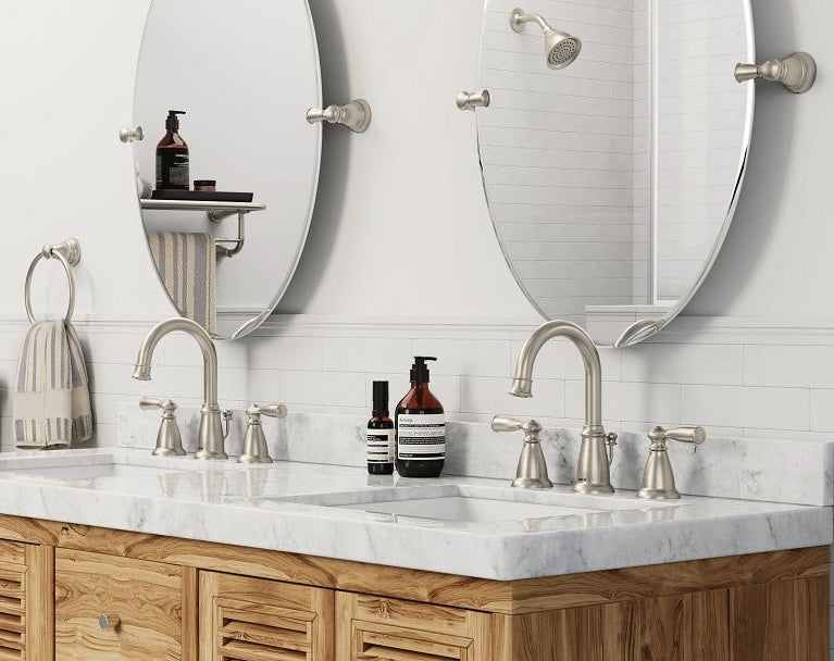 Modern brushed nickel towel ring mounted beside double sink vanity with marble countertop in bathroom setting