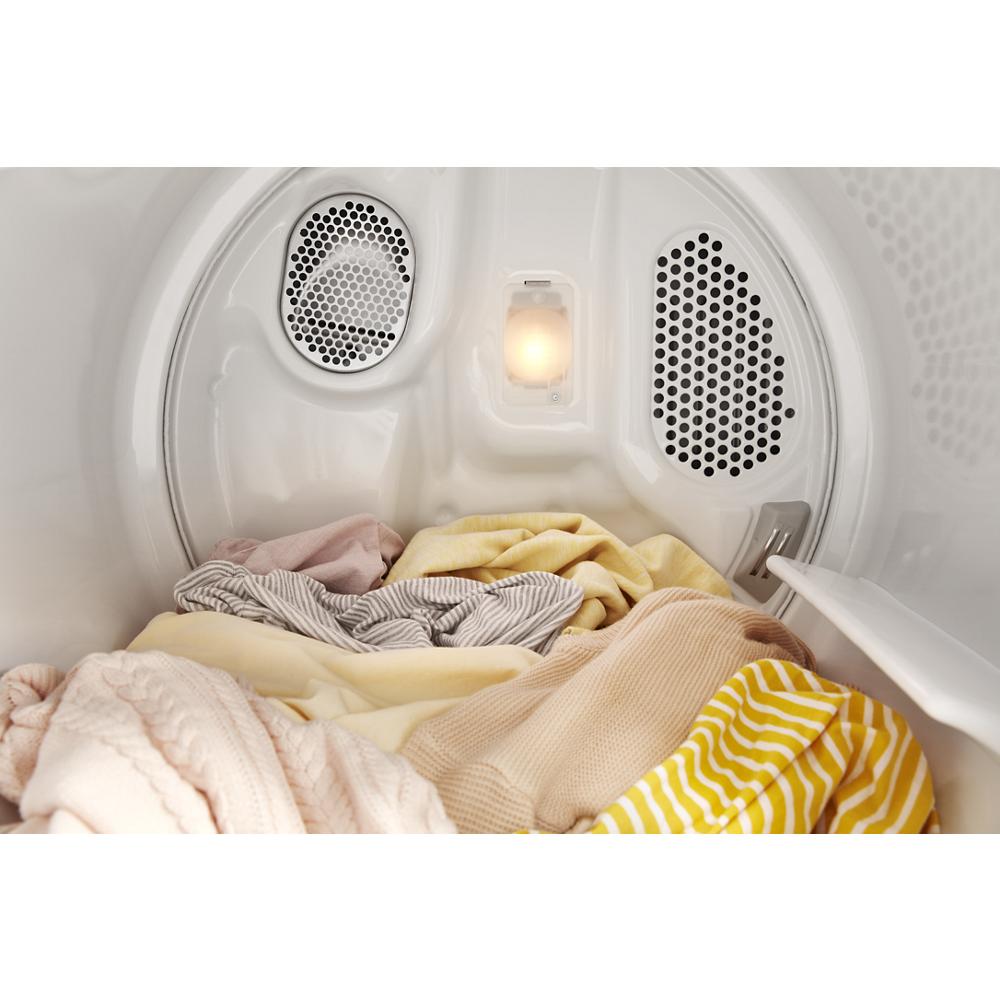 Interior view of a gas dryer drum with soft-colored clothes inside, part of dryers and appliances collection
