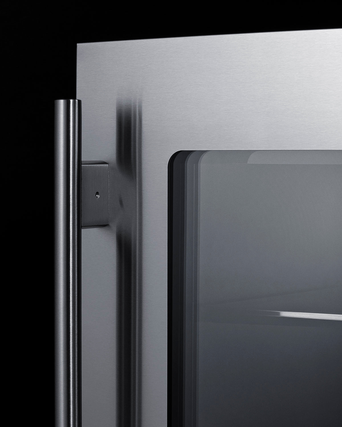 Close-up of stainless steel handle and glass door on built-in beverage center for kitchen and bar settings