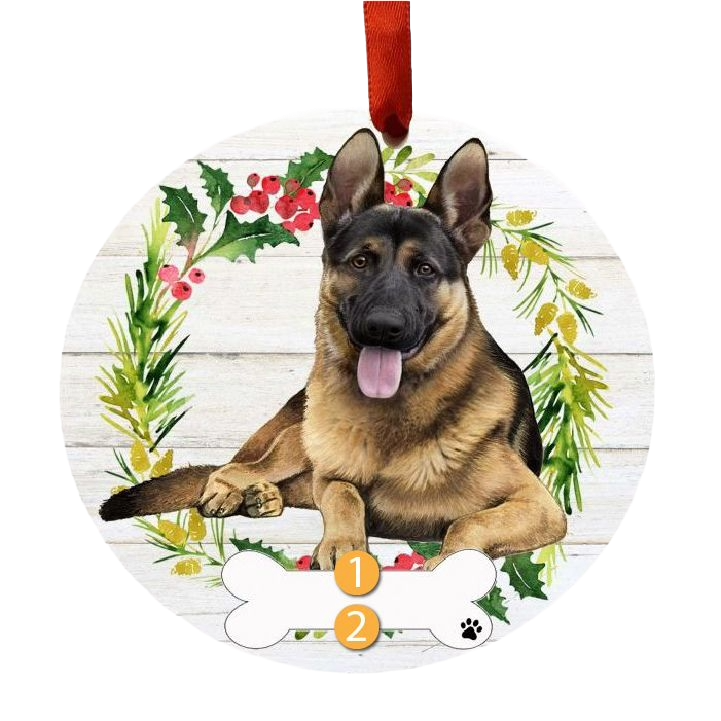 Round Christmas ornament showing a happy German Shepherd lying inside a wreath of holly and greenery with a red hanging ribbon