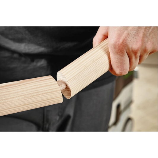 Hand inserting a beech domino tenon into wood joint for woodworking using Festool tool accessories.