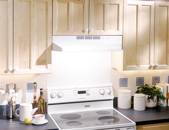 white under-cabinet range hood with rocker controls and built-in light above electric stove in kitchen setting
