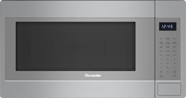 Stainless steel built-in microwave with digital clock and keypad controls, left side opening door in kitchen appliances collection