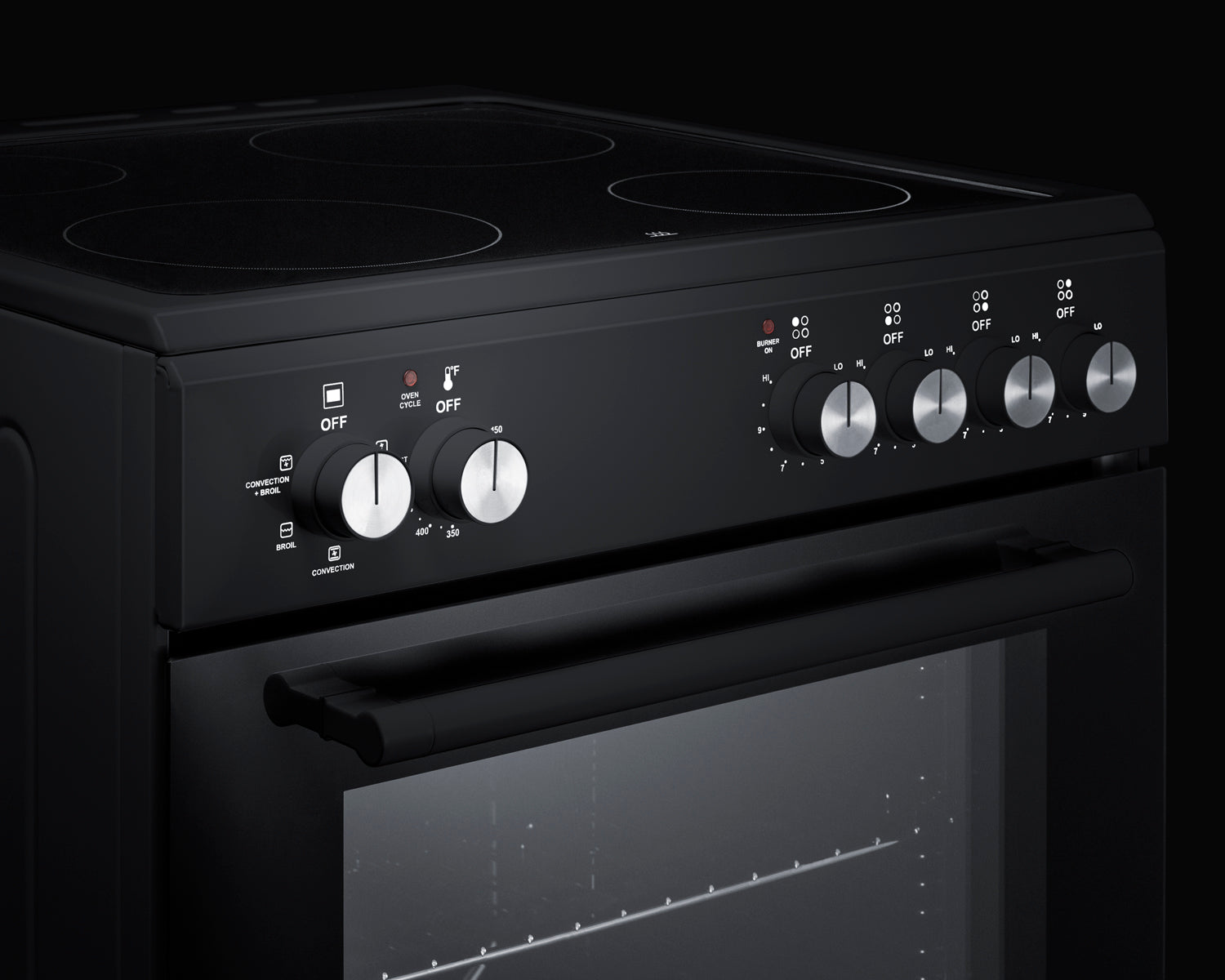 Close-up of black electric smooth-top range control panel with five silver knobs and glass oven door handle