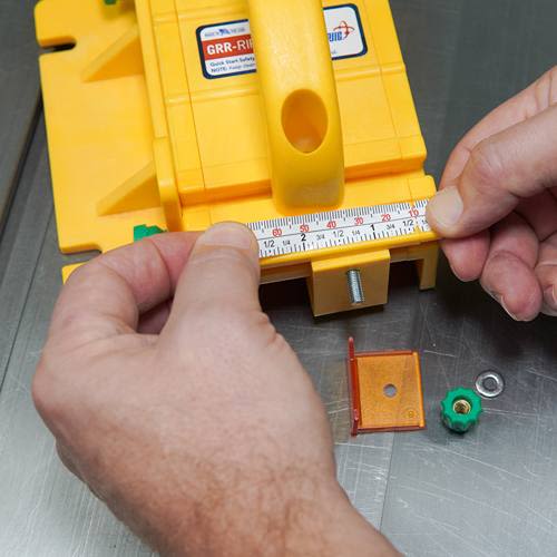 Hands adjusting measurement tool on yellow saw accessory in power tool and saw accessories collections under $50