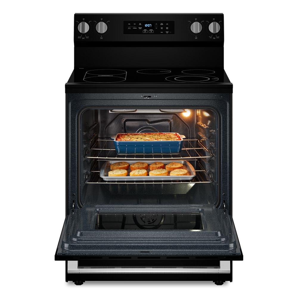 Black 30-inch electric range with open oven door showing baked dishes inside for kitchen appliance use