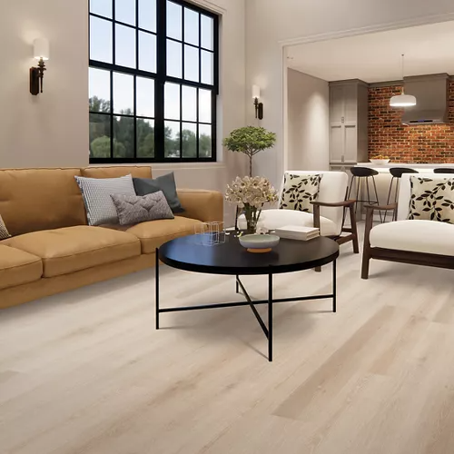 Spacious living room with light wood-look flooring, modern furniture, and bright natural lighting for home improvement inspiration