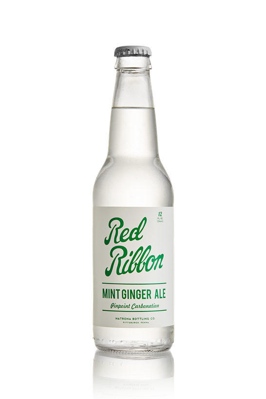 Clear glass bottle of Red Ribbon Mint Ginger Ale with green text label and silver cap on white background