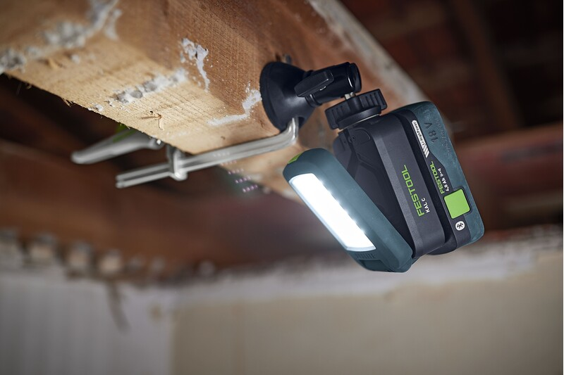 Magnetic Syslite adapter base attached to wooden beam supporting LED work light in home improvement tools collection