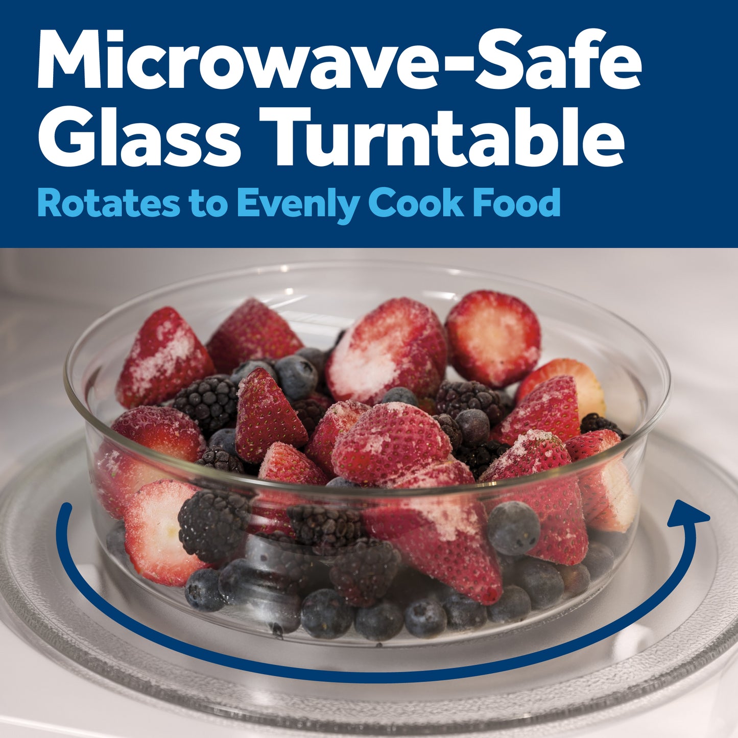 Clear glass turntable inside microwave with fresh mixed berries for even cooking in kitchen appliances.