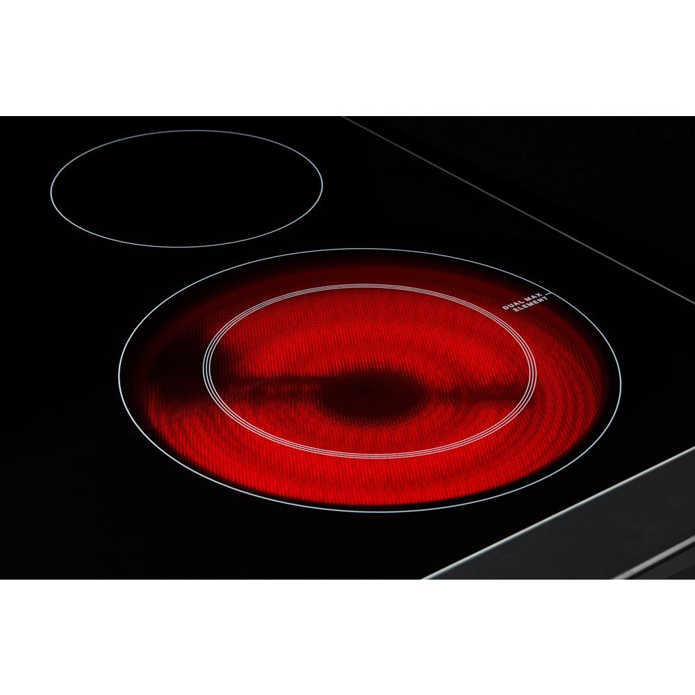 Close-up of glowing red radiant heating element on smooth black glass cooktop in ranges and kitchen appliances collection