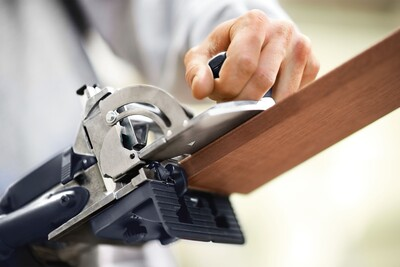 Close-up of woodworking tool stabilizing a wooden board for precise joinery, part of Festool Domino joiner accessories.