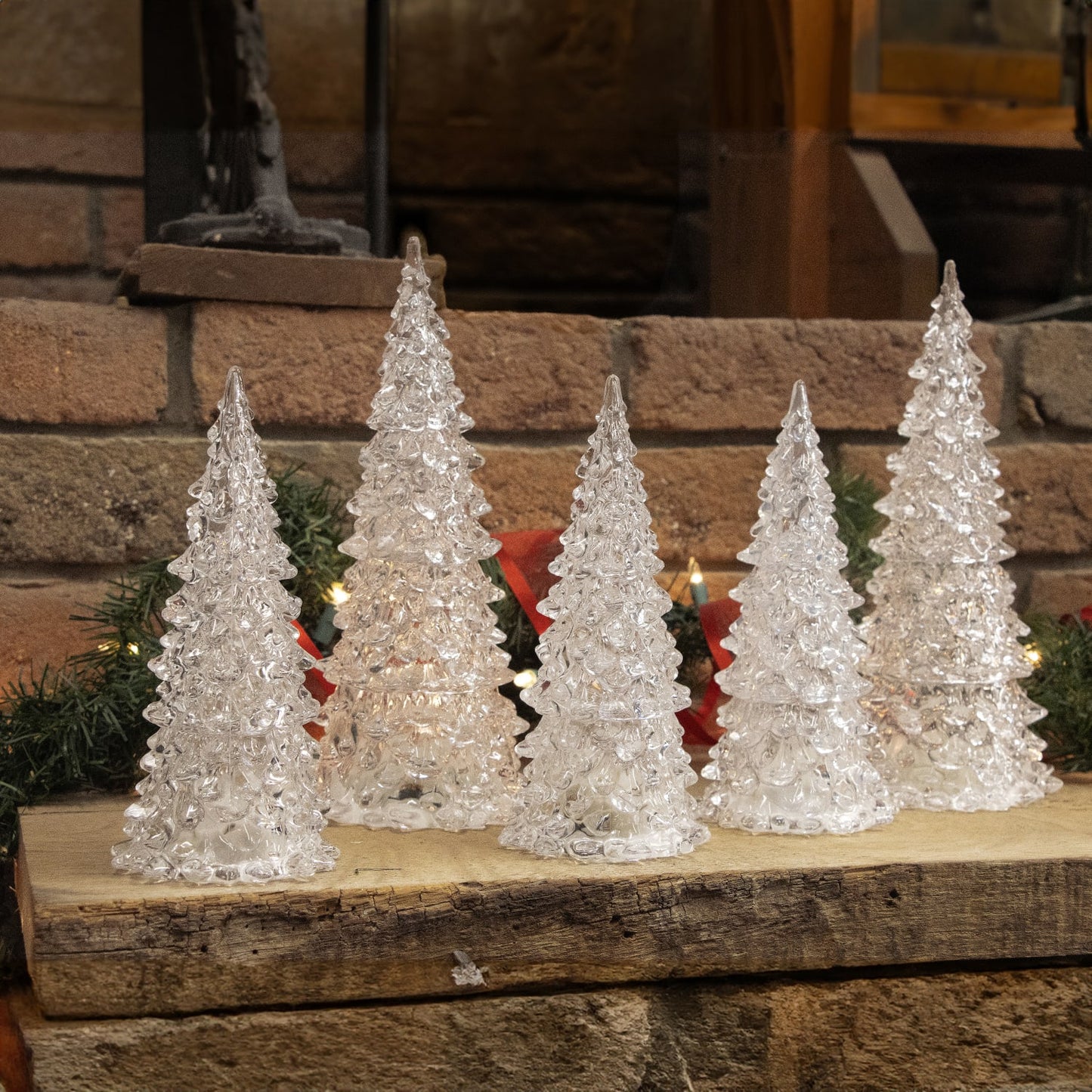 Set of five translucent multicolor light-up decorative trees with textured surfaces for seasonal home accents