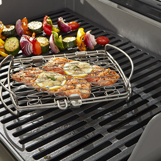 Stainless steel fish grilling basket with flexible design on gas grill, part of outdoor cooking and grilling accessories