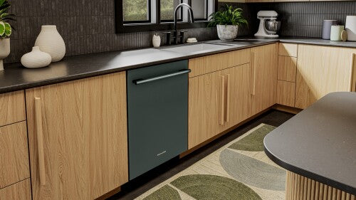 Built-in dark green KitchenAid dishwasher with towel bar handle integrated into modern wood kitchen cabinetry and black countertop