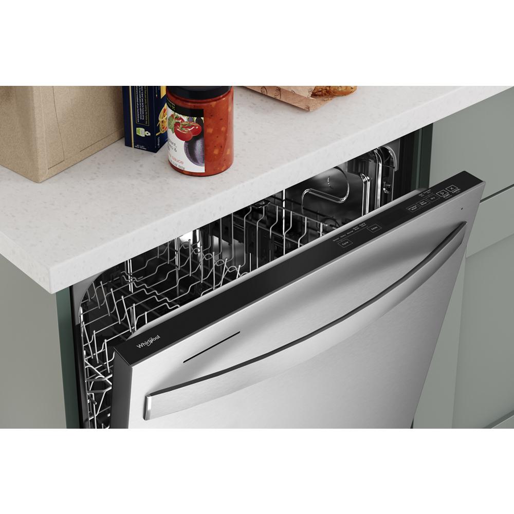 Partially open stainless steel dishwasher with control panel and spacious interior racks in modern kitchen appliances collection