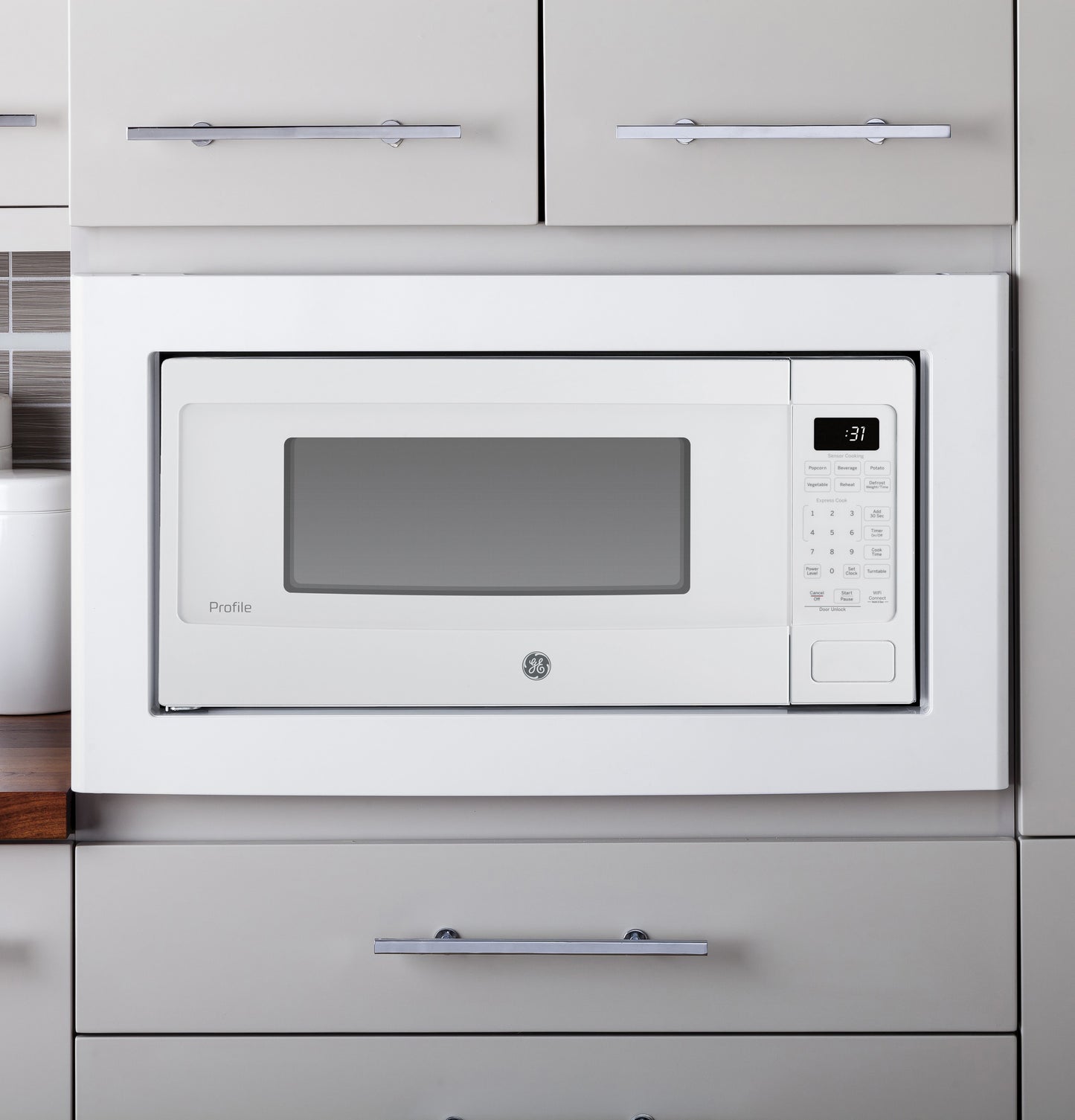 White built-in microwave oven with digital display and control panel in kitchen and appliances collection