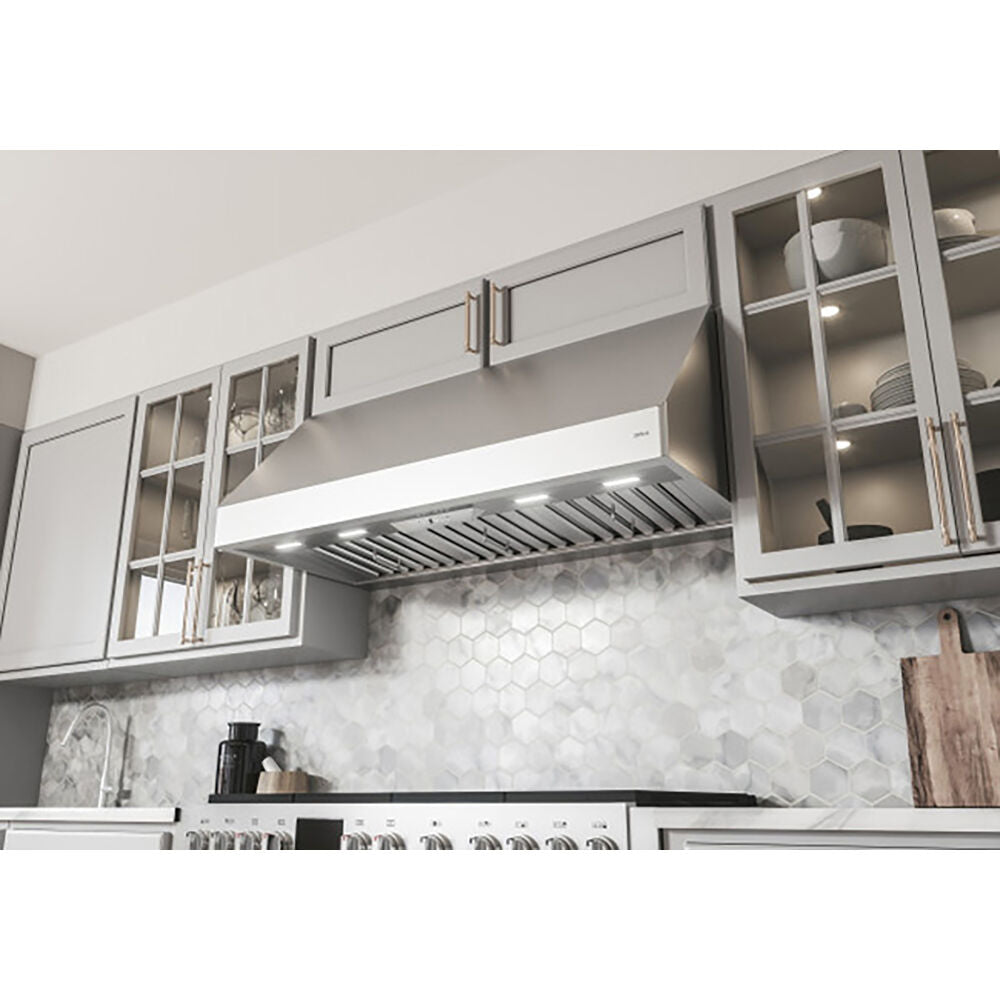 Stainless steel canopy hood with LED lighting above stove and hexagonal tile backsplash in kitchen and range hoods collection
