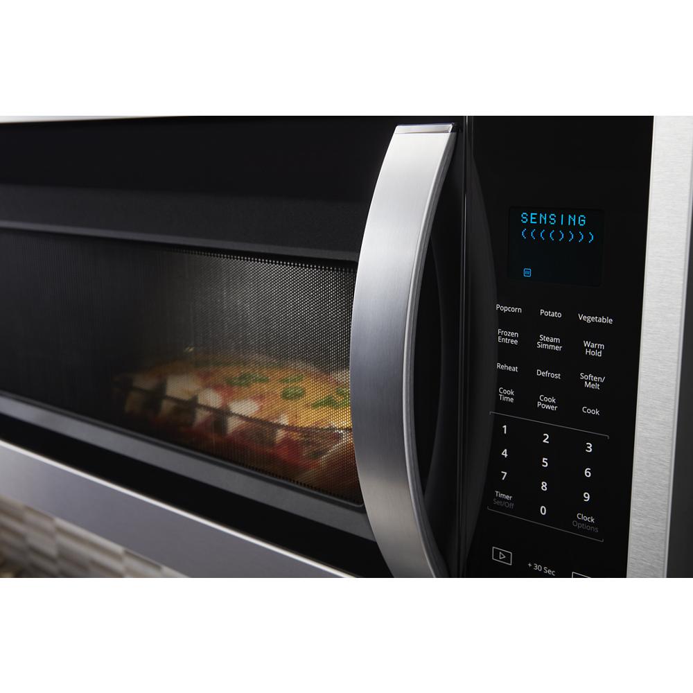 Close-up of stainless steel microwave control panel with sensor cooking and preset options in kitchen appliances category