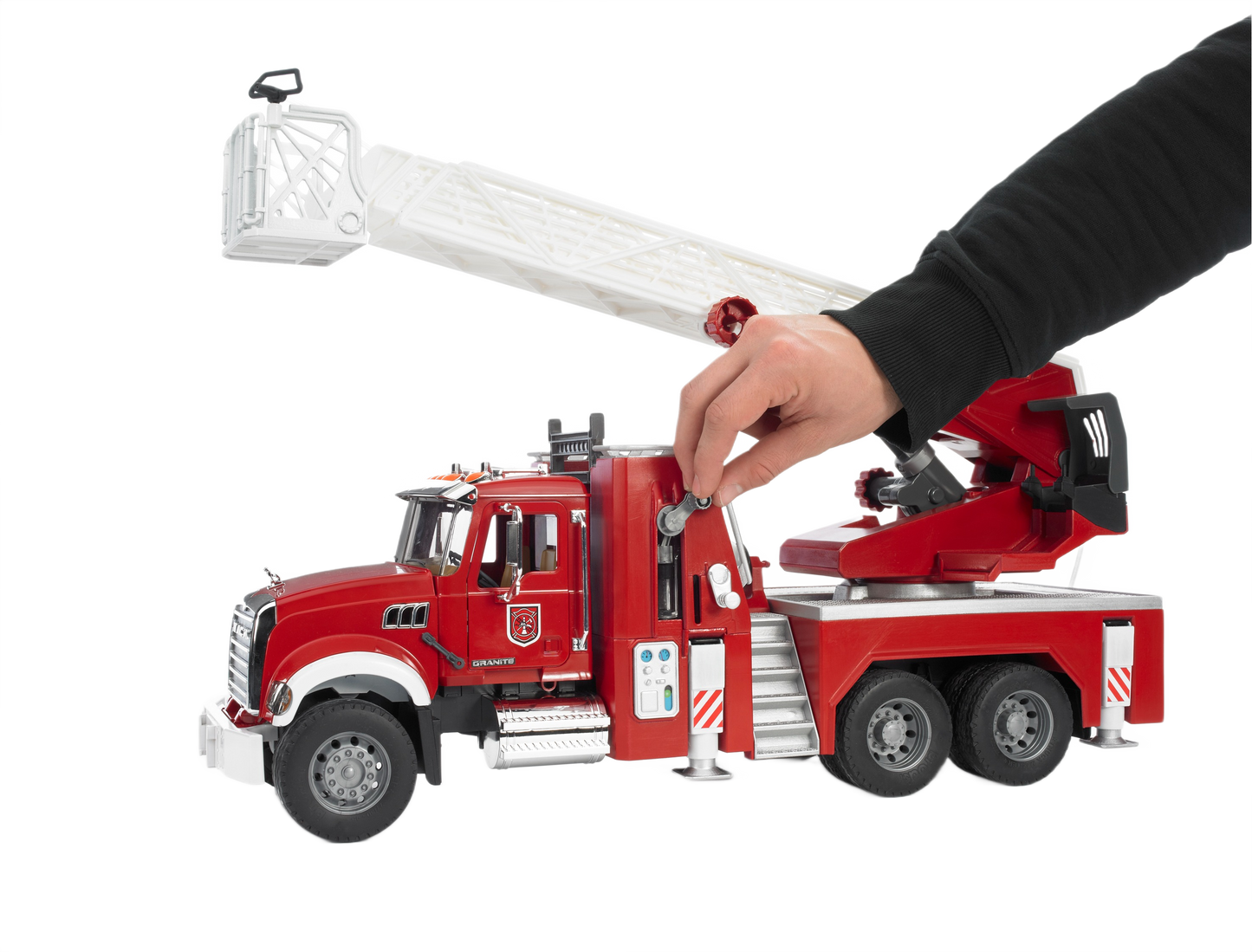 Red Bruder Toys fire engine model with extendable white ladder and detailed water pump, held by a hand for scale