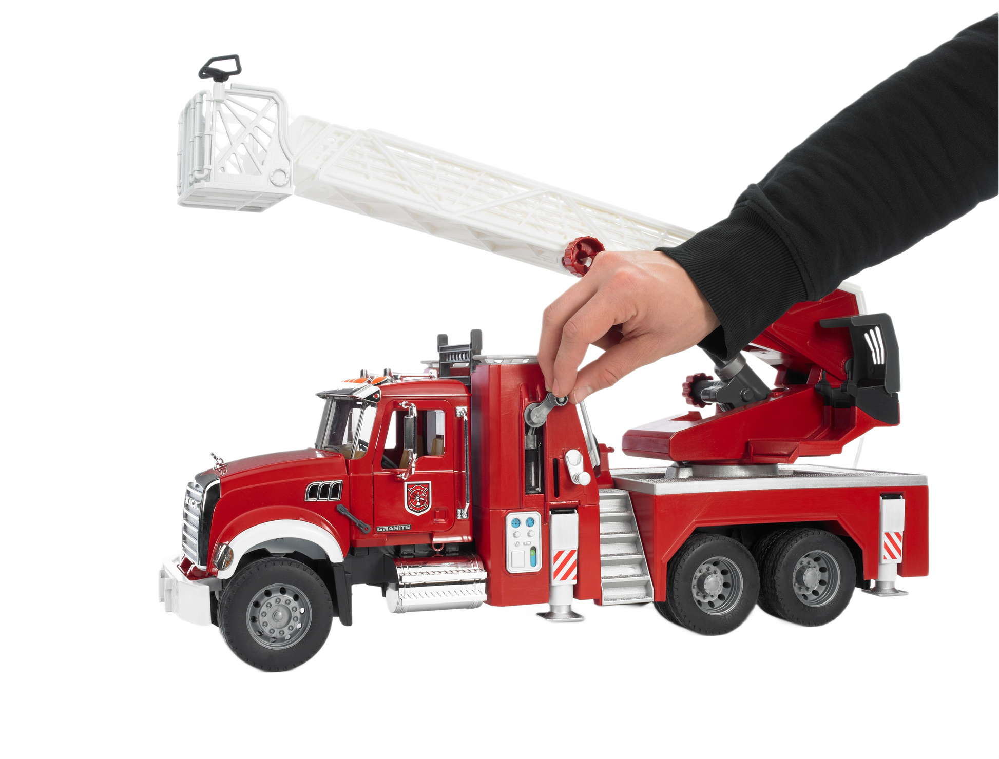 Red Bruder Toys fire engine model with extendable white ladder and detailed water pump, held by a hand for scale