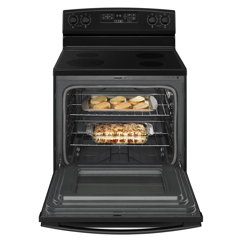Open 30-inch Amana electric range oven with casserole and toasted bread inside from kitchenware collection