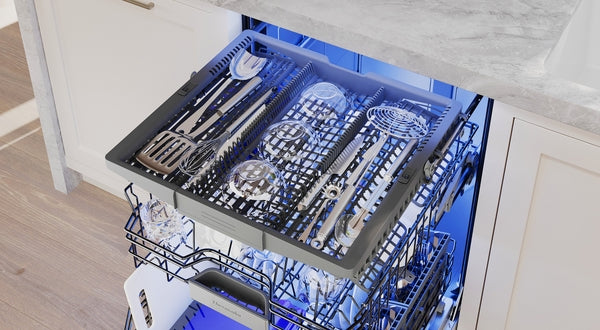 Open dishwasher drawer with organized silver utensils and kitchen tools inside from Thermador kitchen appliances collection