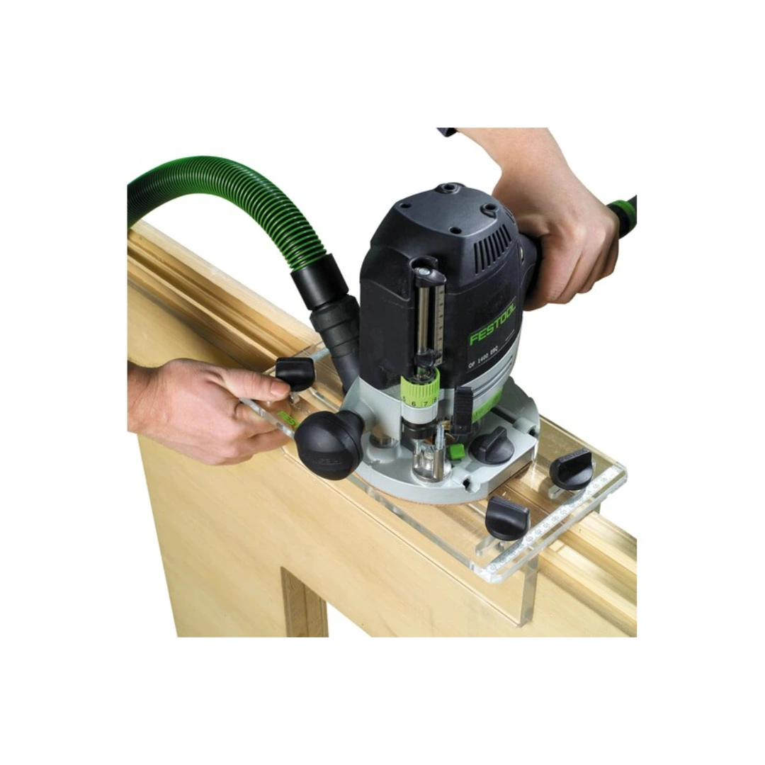 Hands guiding a Festool router attached to a clear plexiglass guide for precise woodworking tool accessory use