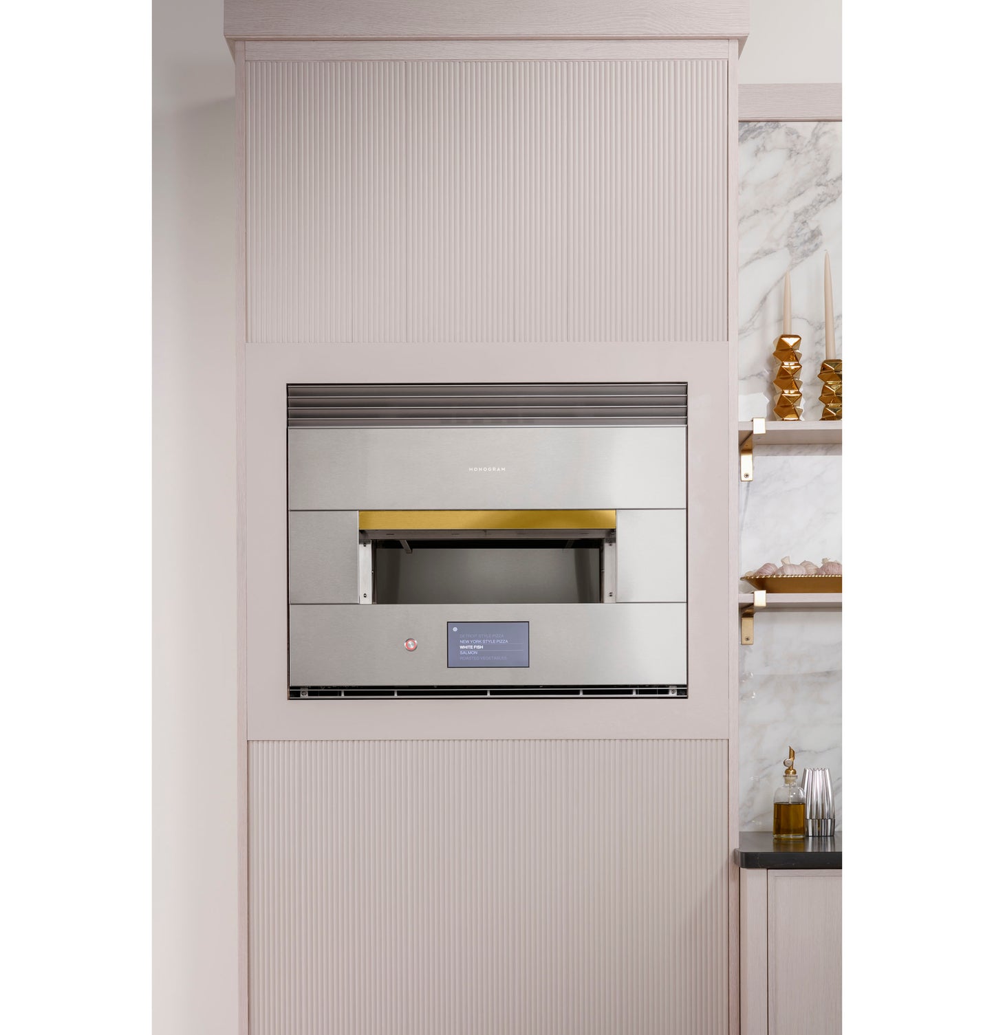 Built-in stainless steel hearth oven with digital display, integrated in modern kitchen cabinetry and decorative shelving nearby
