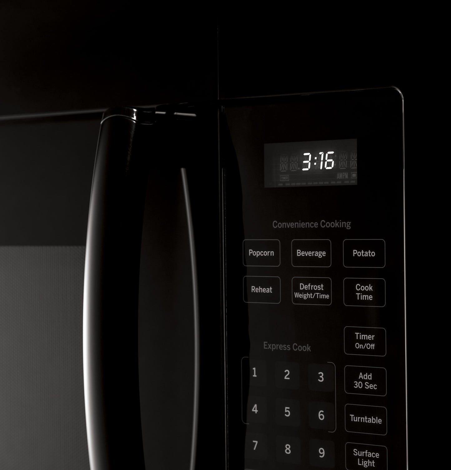 Close-up of black over-the-range microwave control panel with digital clock and preset cooking buttons from appliances collection