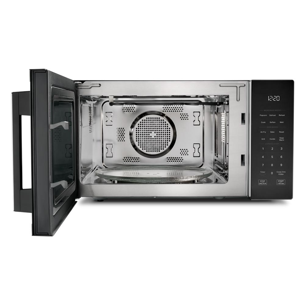 Black multifunctional countertop microwave with open door showing stainless steel interior and digital control panel