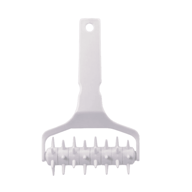 Compact white plastic dough docker with multiple raised spikes for even perforation in kitchen gadgets collection